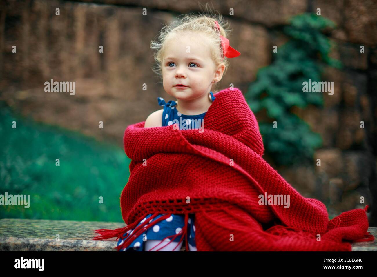 young girl sits wrapped in a blanket Stock Photo - Alamy