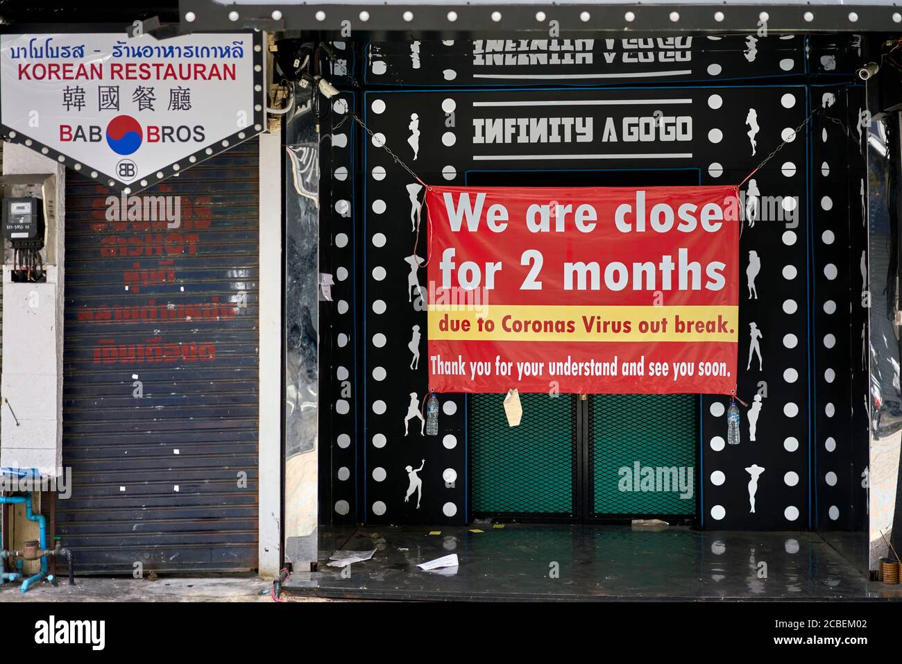 Covid 19 business effect with sign announcing 2 months closure of premises. Thailand Southeast Asia Stock Photo