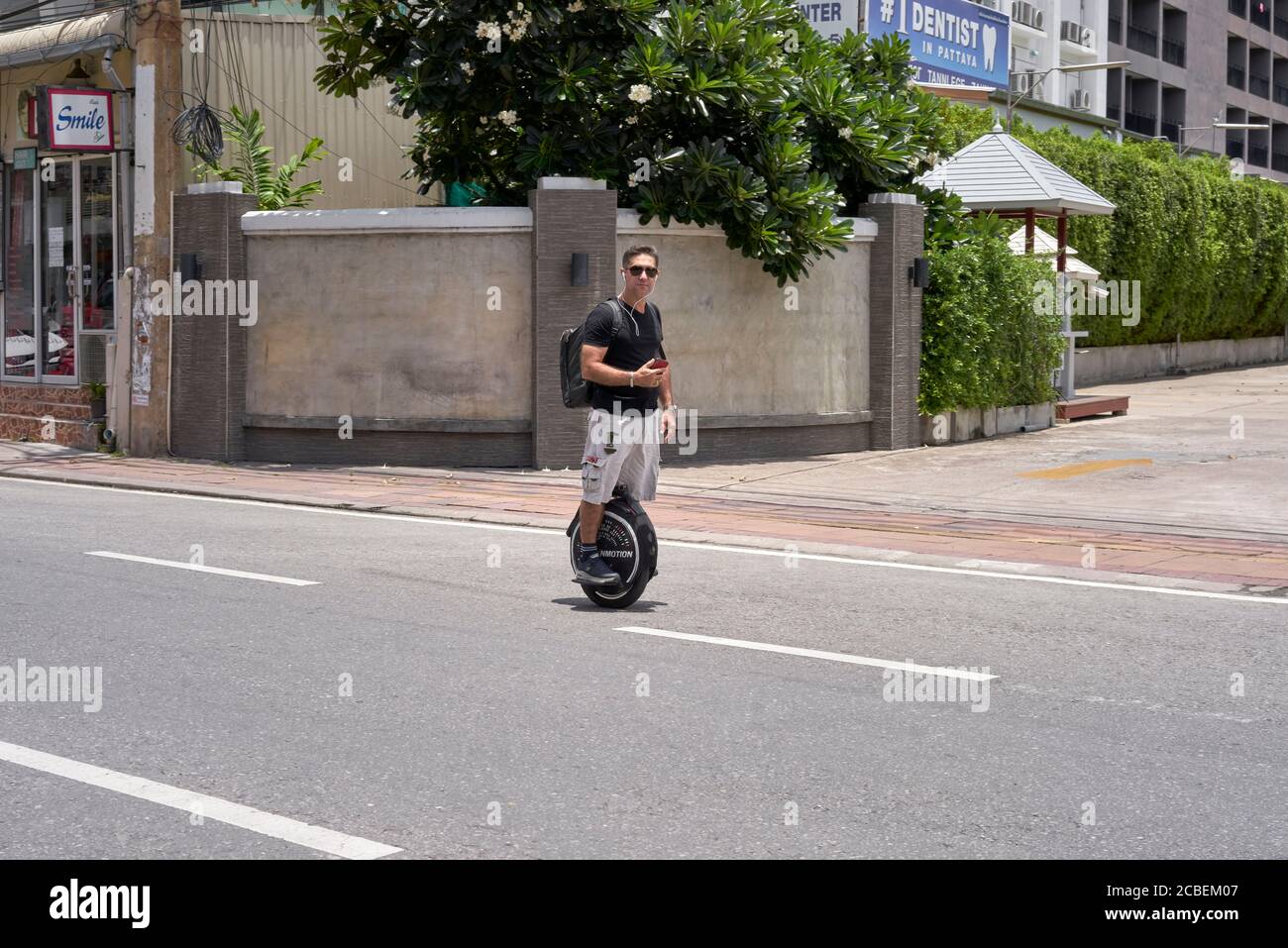 Electric unicycle. Man riding a one wheel electric mono wheel along the