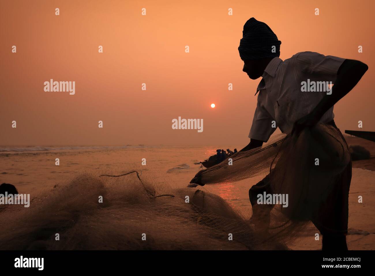Fisherman on the beach near the traditional fishing colony in Puri, Odisha, India Stock Photo