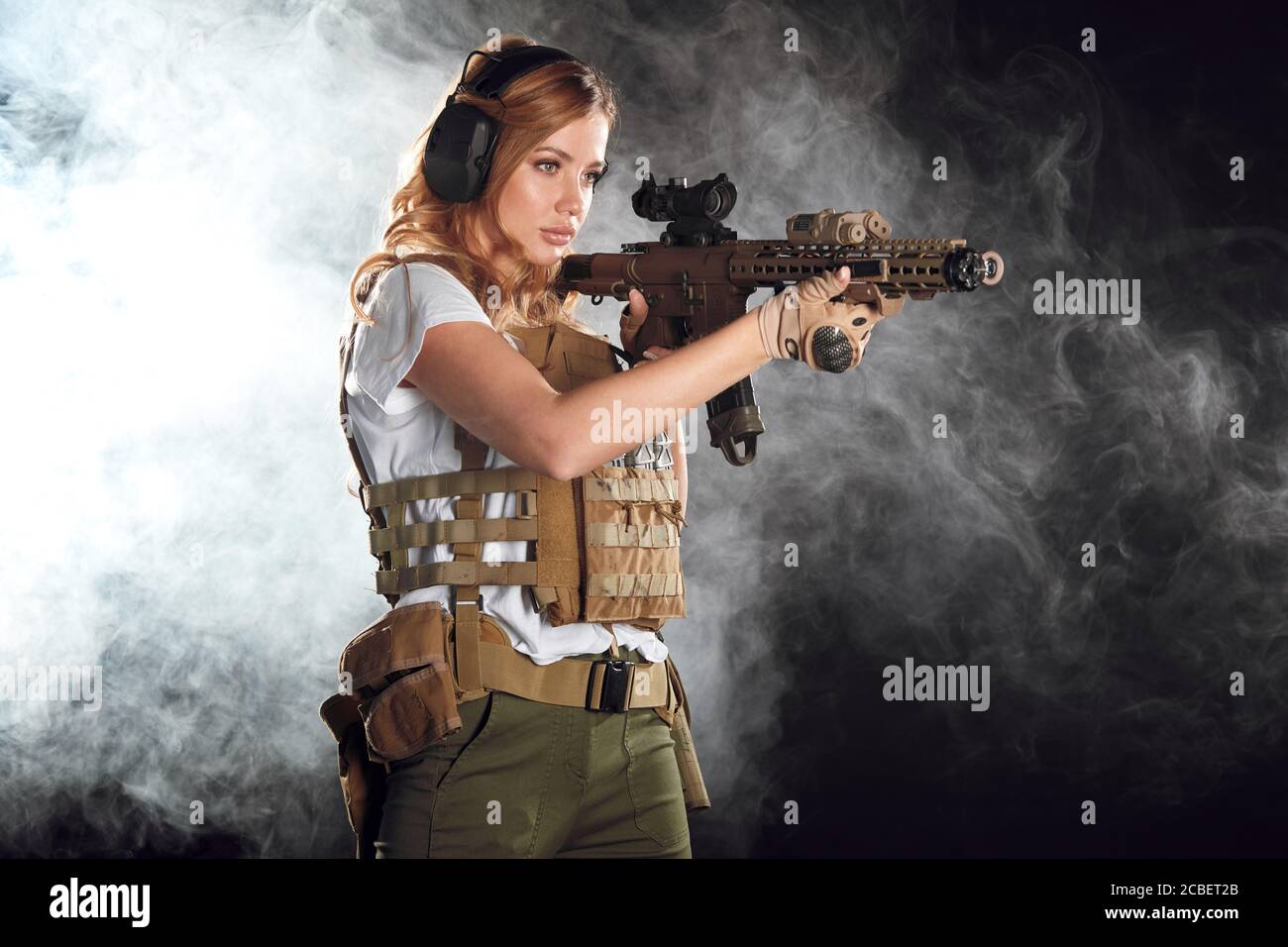 woman sniper with SVD sniper rifle. Female in US Army soldier with rifle. Shot in studio. Stock Photo