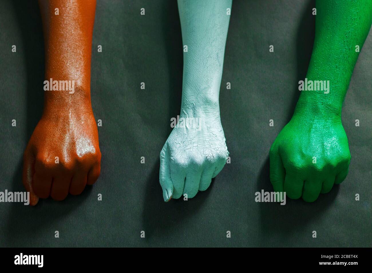 three hands are painted with three colors,saffron,white and green to represent tricolor Indian national flag.15 August Independence day India. Stock Photo