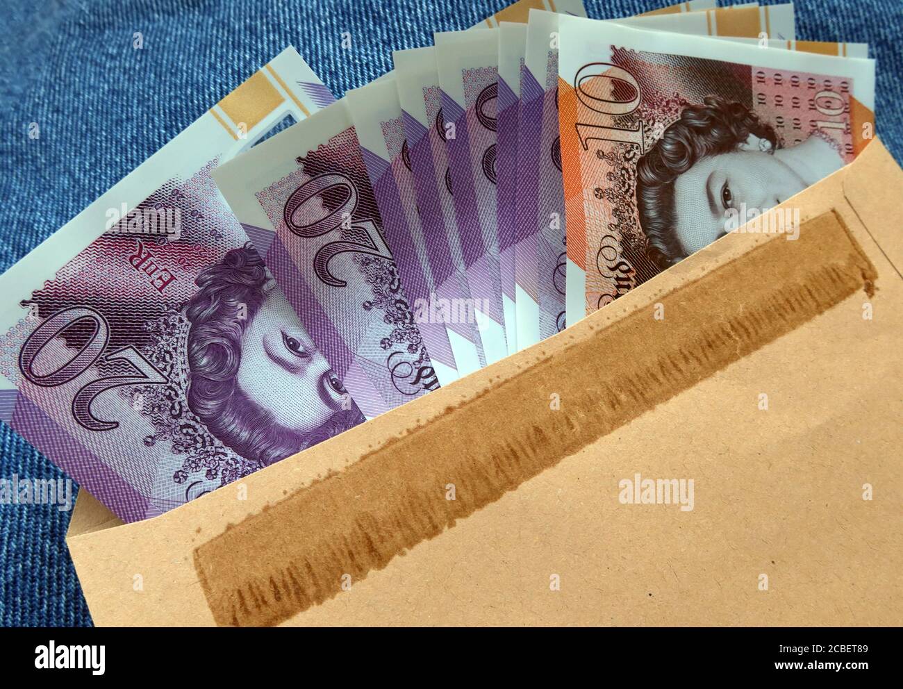 UK English Sterling notes in a brown envelope, Five Pound,Ten Pound,Twenty pound,note, black economy , payment Stock Photo
