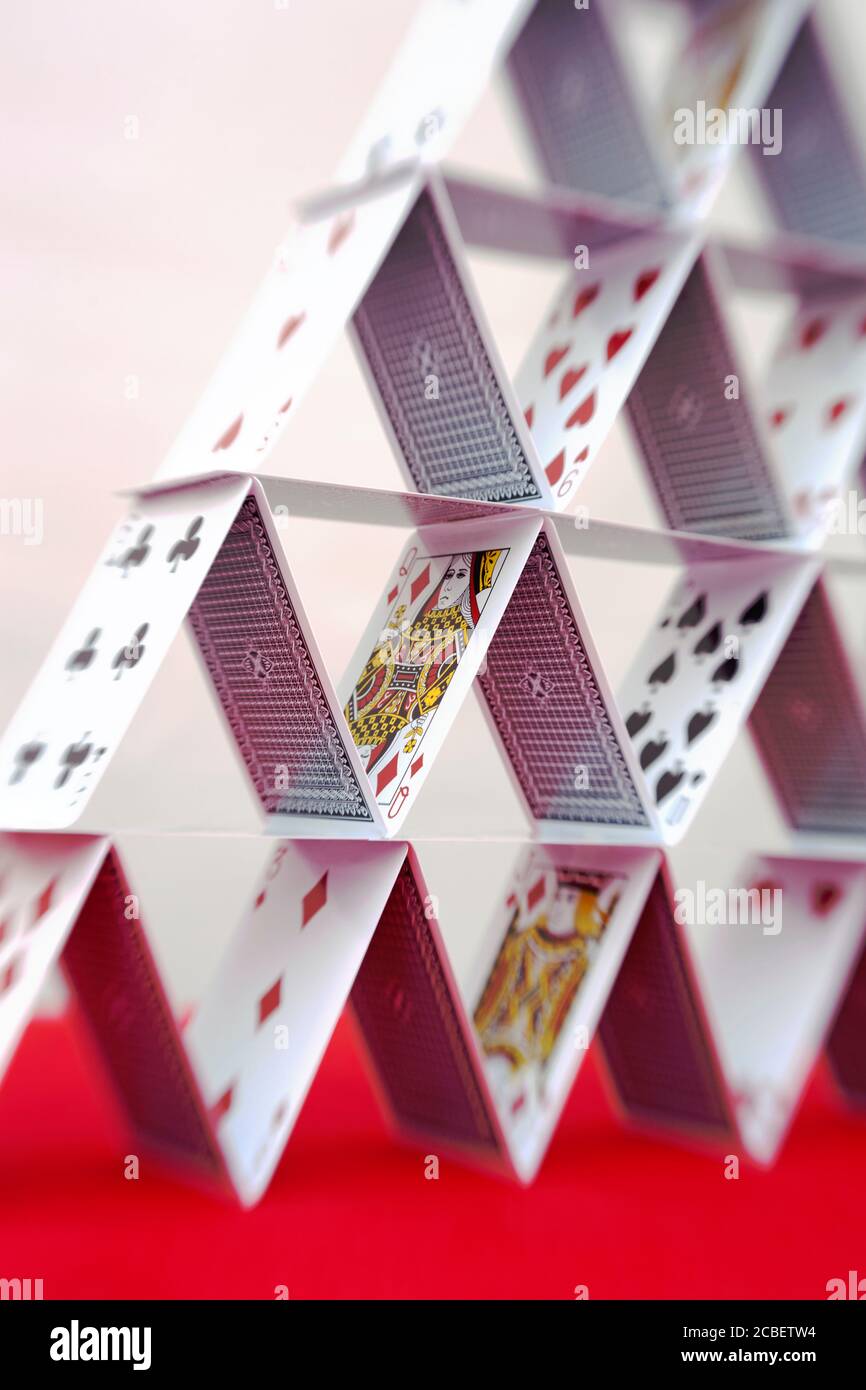 A close up of a pyramid shaped house of cards Stock Photo