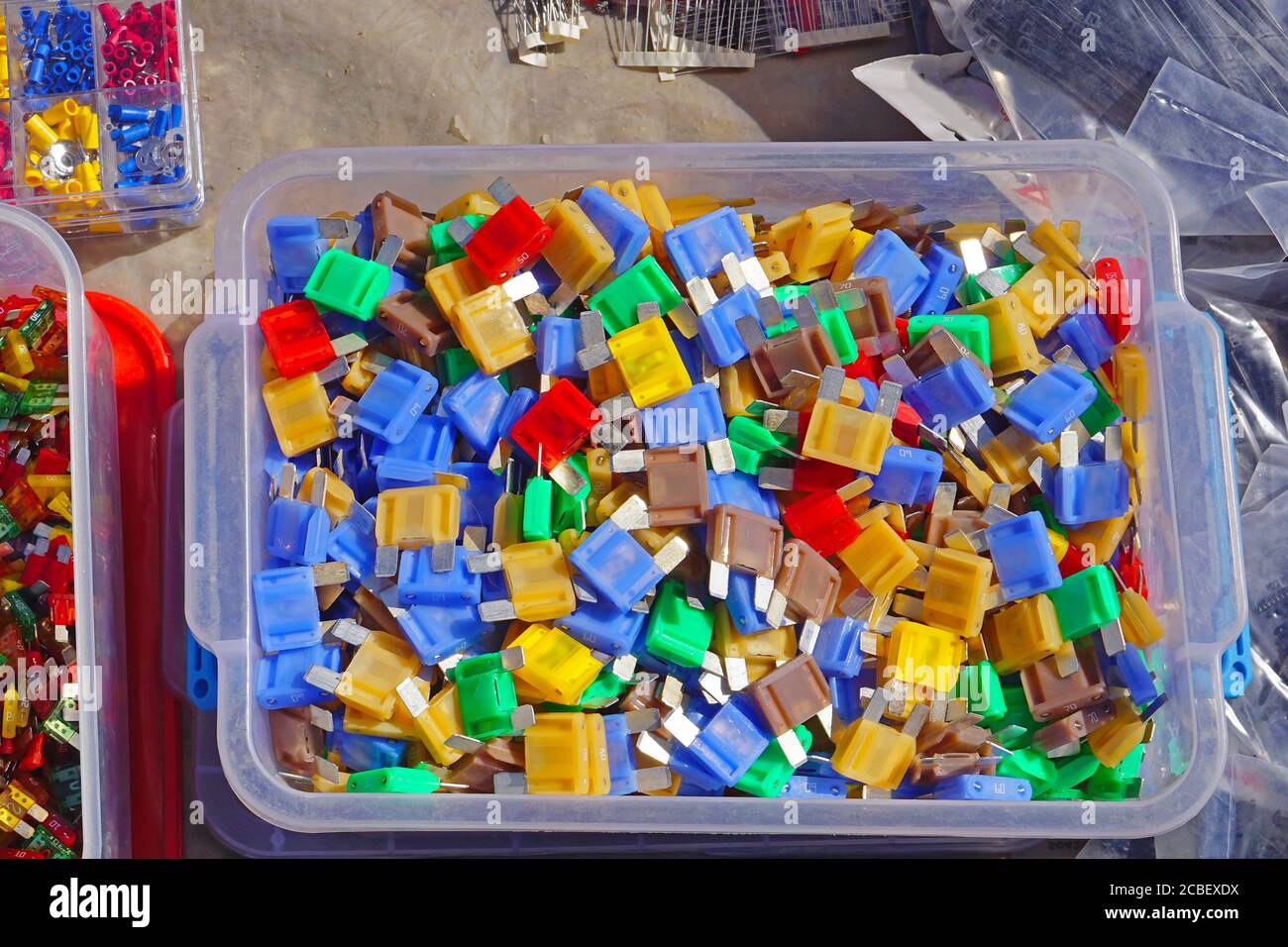 Many color coded fuses for cars in box Stock Photo