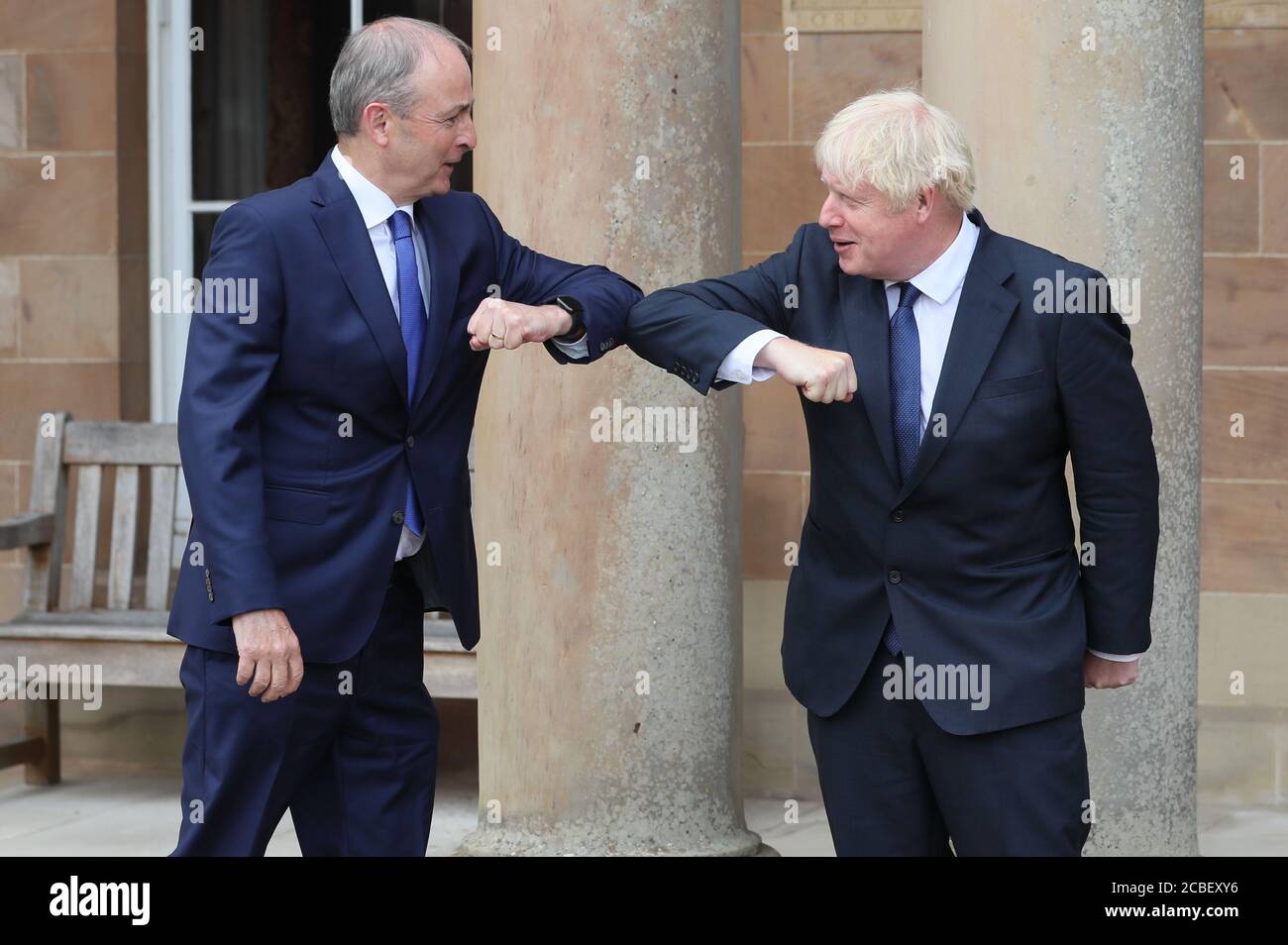 Prime Minister Boris Johnson (right) and Taoiseach Micheal Martin greet each other with an elbow bump at Hillsborough Castle during the Prime Minister's visit to Belfast. Stock Photo