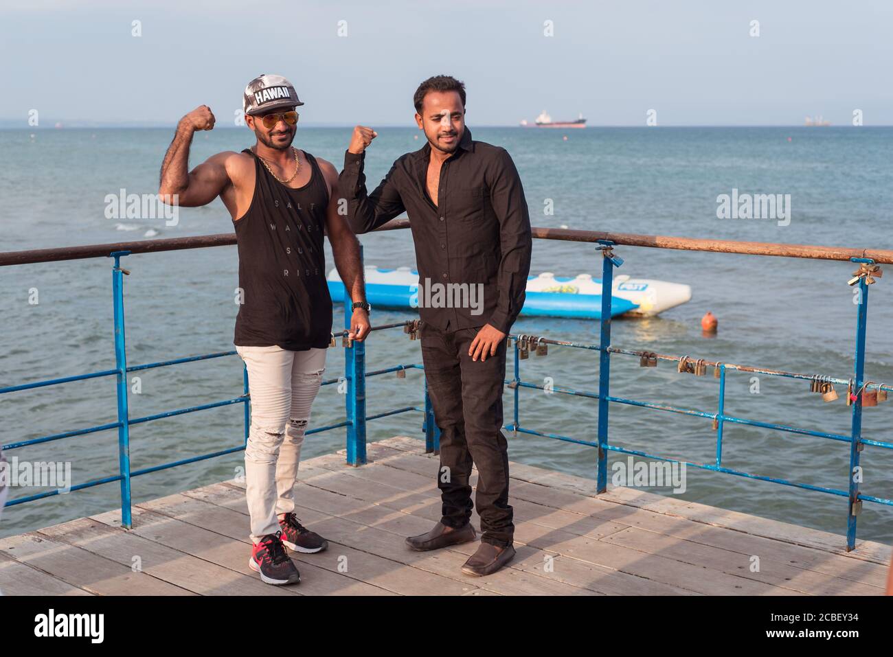 Larnaca / Cyprus - August 15, 2019: tourists taking pictures on the pier on Larnaca beach Stock Photo