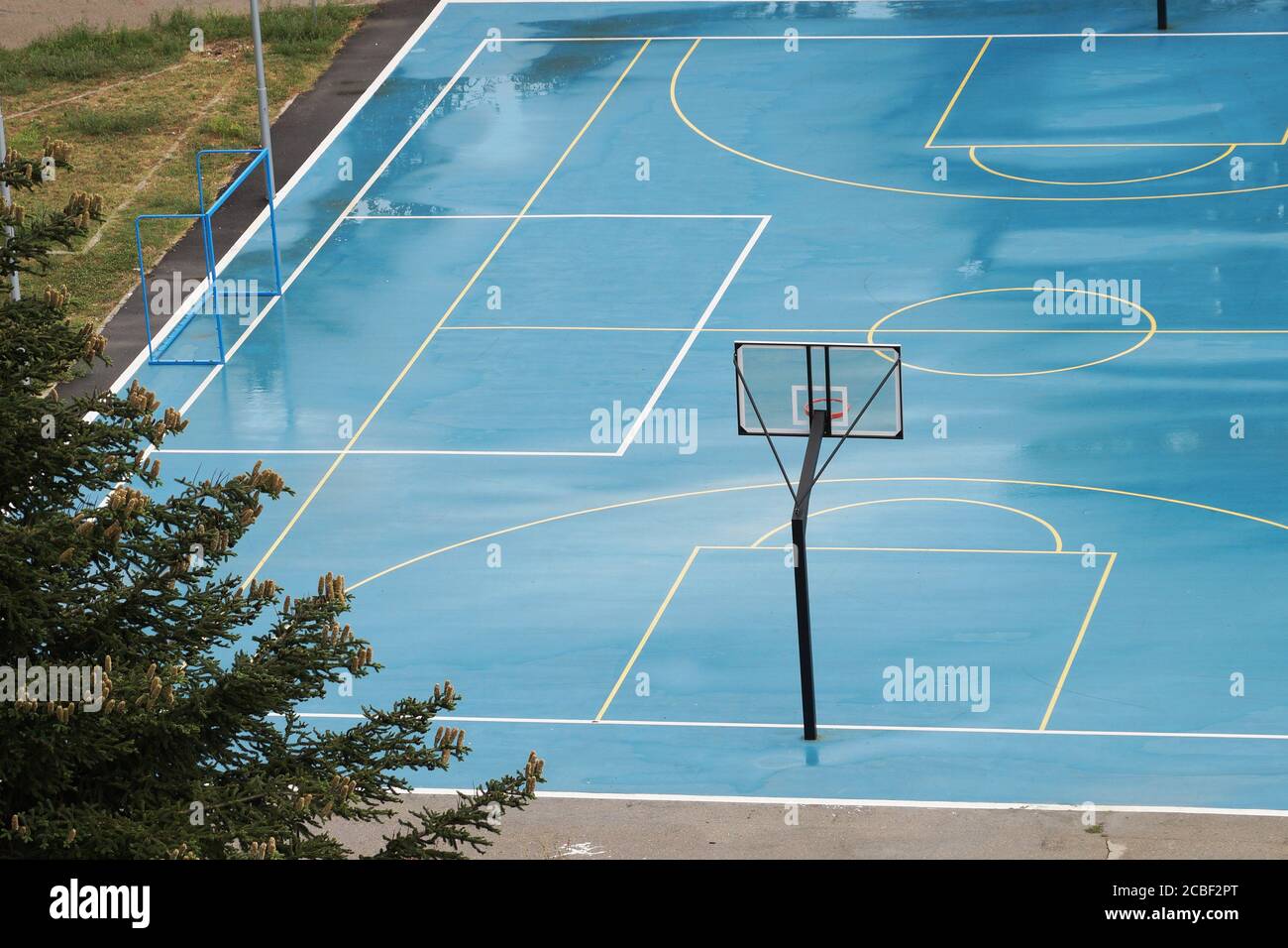 basketball court wet from the rain in a residential area, top view
