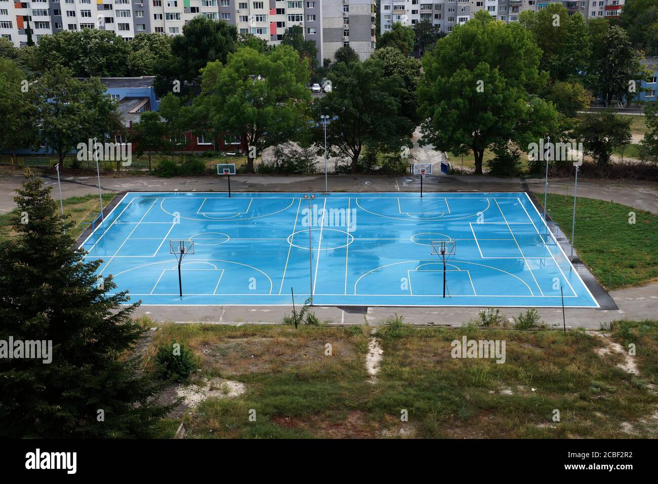 basketball court wet from the rain in a residential area, top view