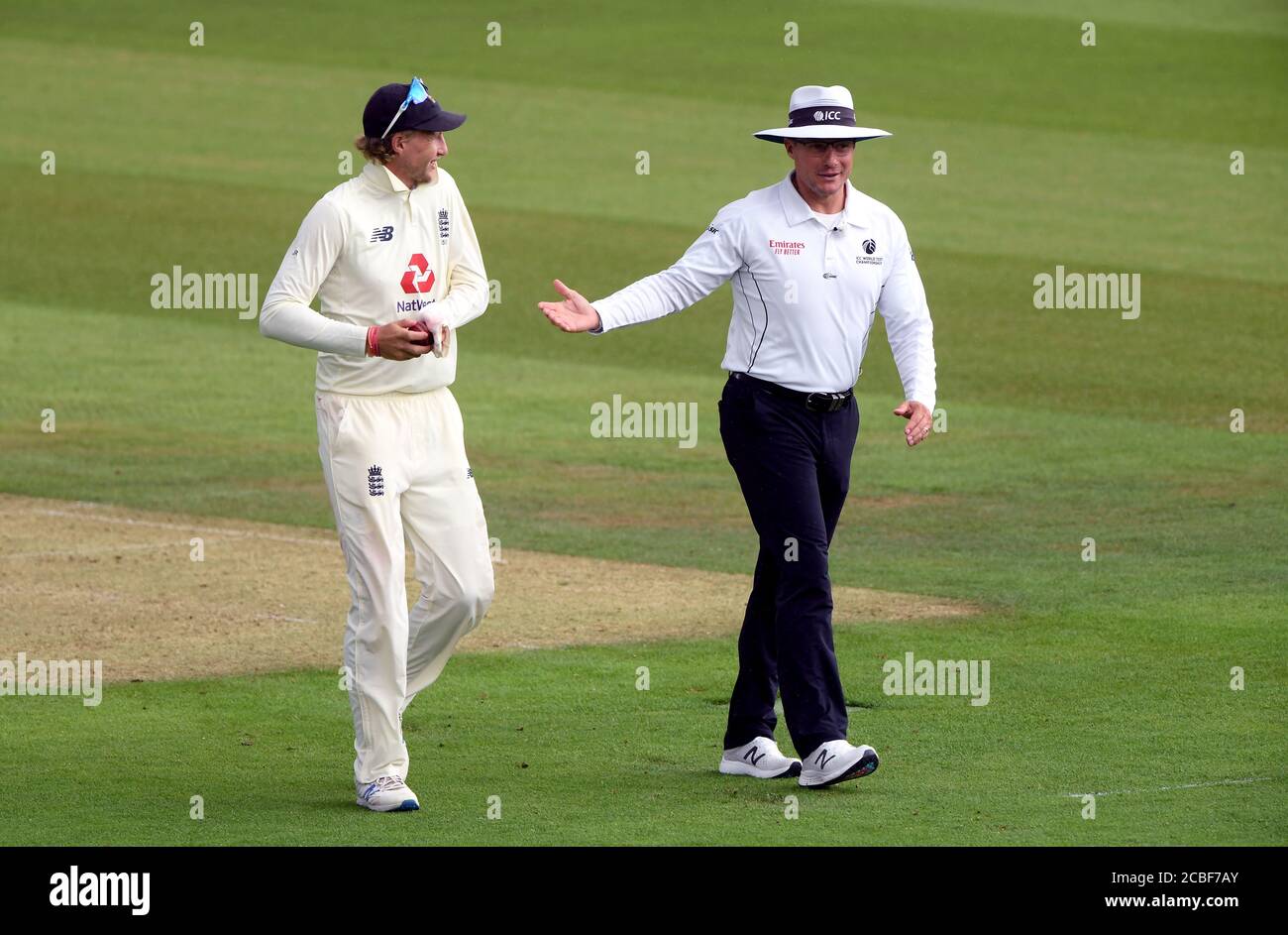 England's Joe Root and umpire Richard Kettleborough talk as they leave the pitch for a rain delay during day one of the Second Test match at the Ageas Bowl, Southampton. Stock Photo