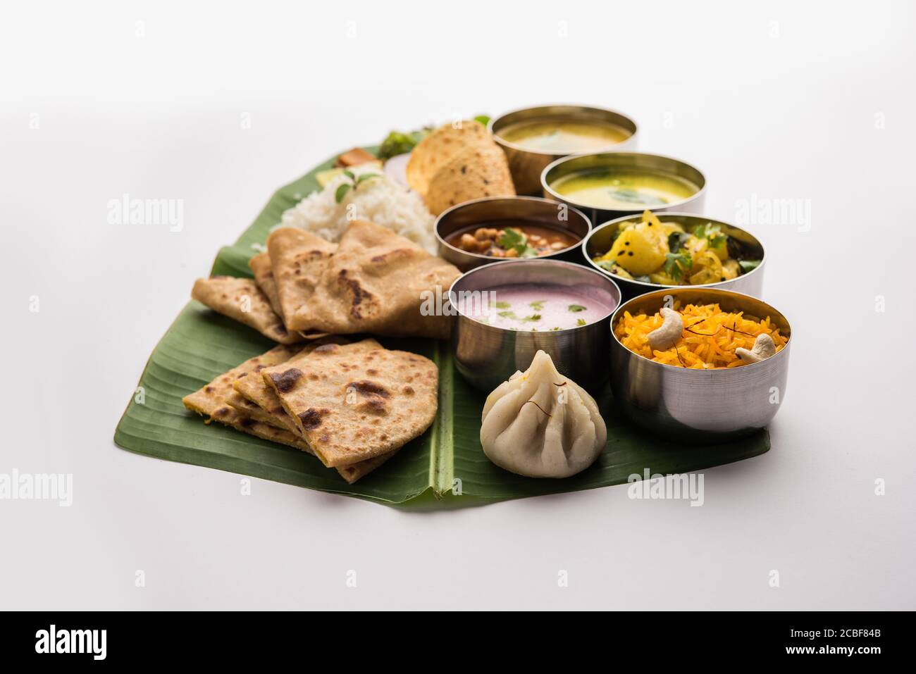 Maharashtrian food Thali or platter - Mumbai style Meal from Indian State Maharashtra includes, roti, rice, dal, sabji, sweet roti and rice, kadhi, Mo Stock Photo