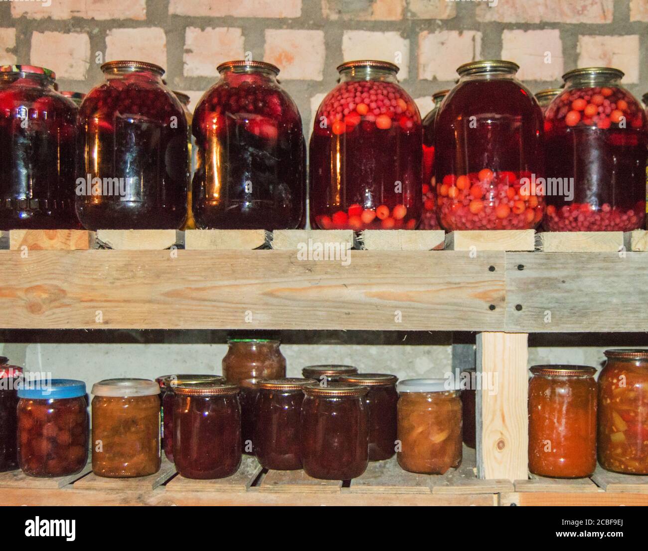 Glass jars for storing food with canned vegetables, fruits and berries