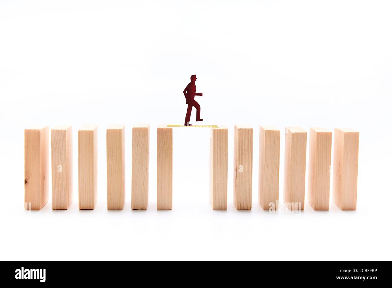 Silhouette of a person passing over wooden tiles. Concept of business support, collaboration Stock Photo