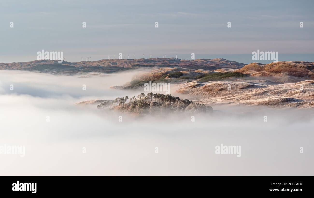 Panoramic view of beautiful cloud inversion, observed at sunrise from the slopes of Ben Cruchan as the hills above Loch Awe emerge from the sea of clo Stock Photo