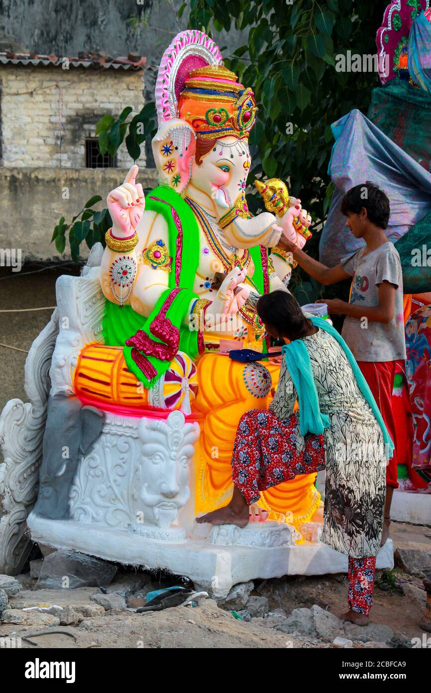 Local roadside artists making statue of god Ganesha using Plaster of
