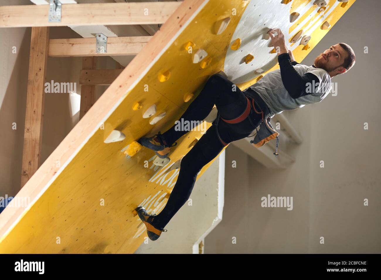 Handsome athletic male mountaineer with physical disability climbing at