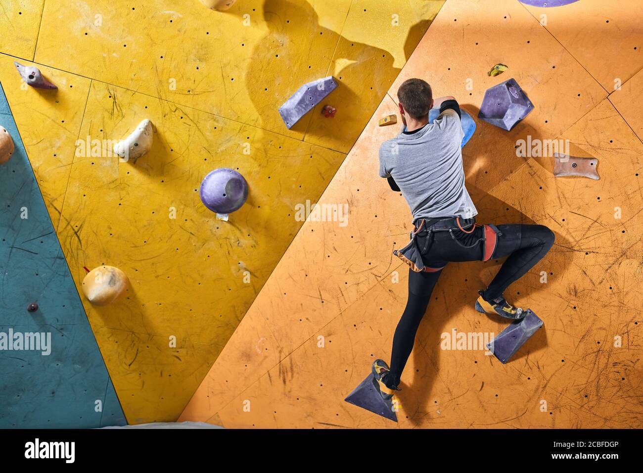 Full length view of rock climber with strong and flexible body shape