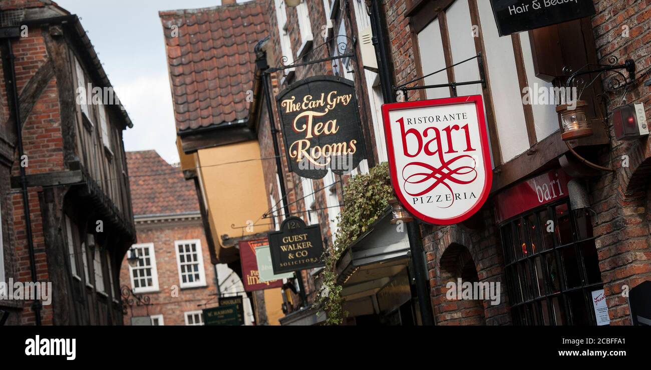 Shop signs in The Shambles, an old street in the City of York, Yorkshire, England. Stock Photo