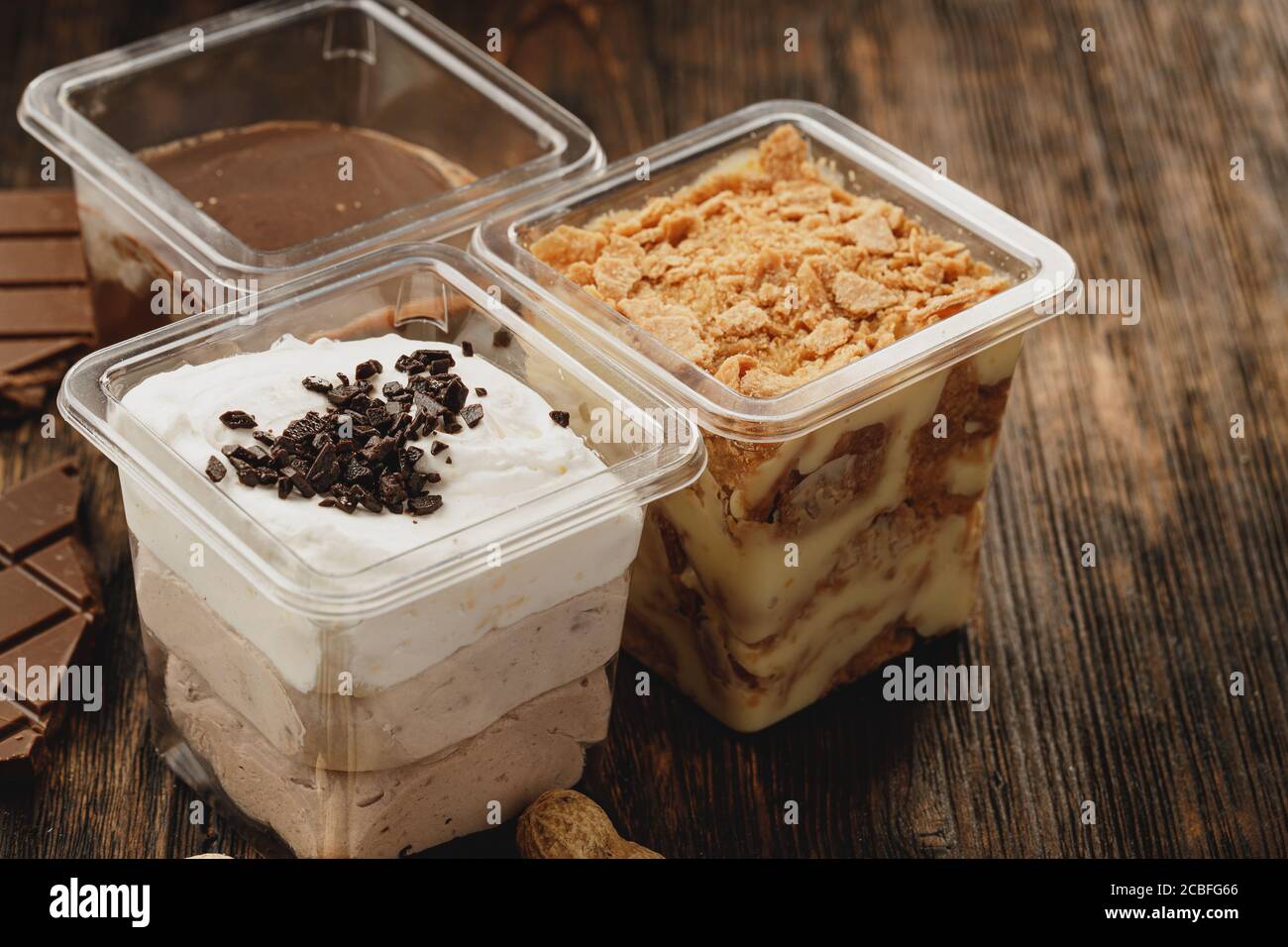 Assortment of delicious dessert boxes on wooden table Stock Photo - Alamy