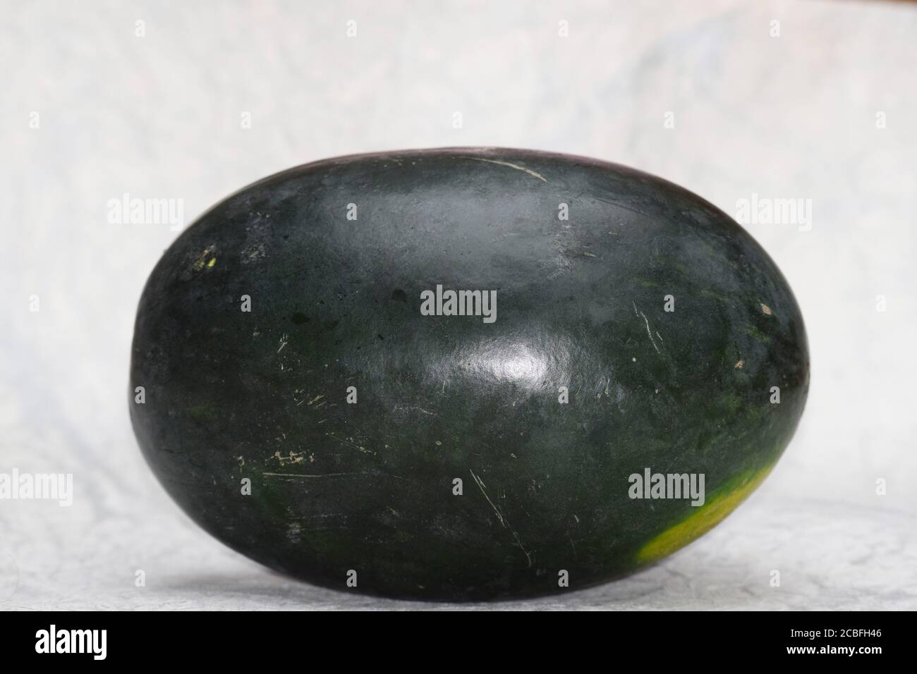 Watermelon fruit from Asia India. Fresh Indian fruit water melon also known as Tarbuz in India, Pakistan, Nepal isolated single piece on white backgro Stock Photo