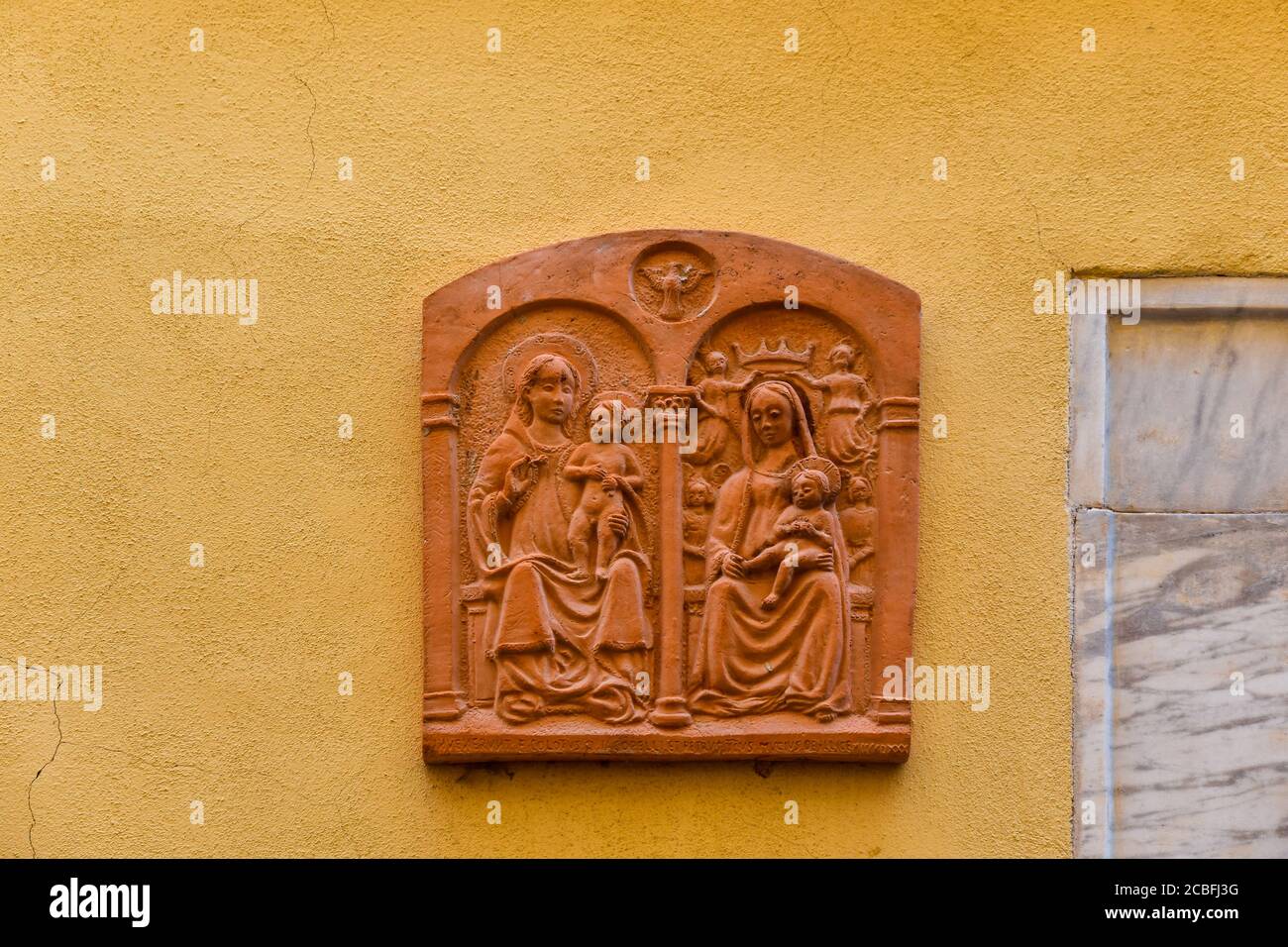 A terracotta tile reproducing the ancient painting of Our Lady of Maralunga, traditionally hanging at the entrance of each new house, Lerici, Italy Stock Photo