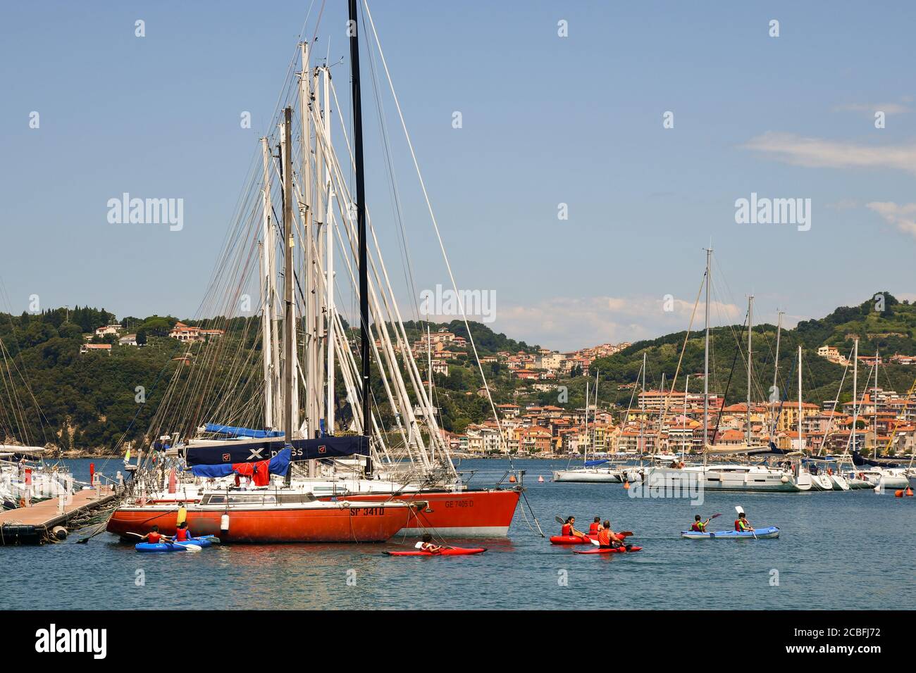A group of young boys during a kayak lesson with an adult instructor in the harbor of the old sea town, Lerici, La Spezia, Liguria, Italy Stock Photo