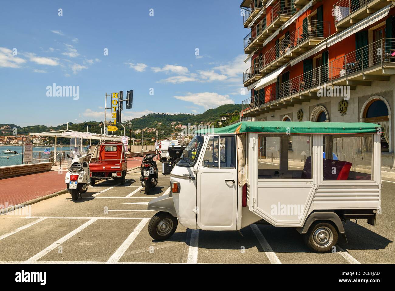 Piaggio Ape Calessino used to transport tourists parked in front of a beachfront hotel in summer, Lerici, La Spezia, Liguria, Italy Stock Photo