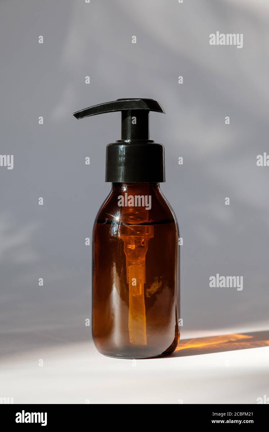 Download Cosmetic Dark Amber Glass Bottle On White Background Minimalist Style Pump Dispenser Packaging Design Branding Stock Photo Alamy