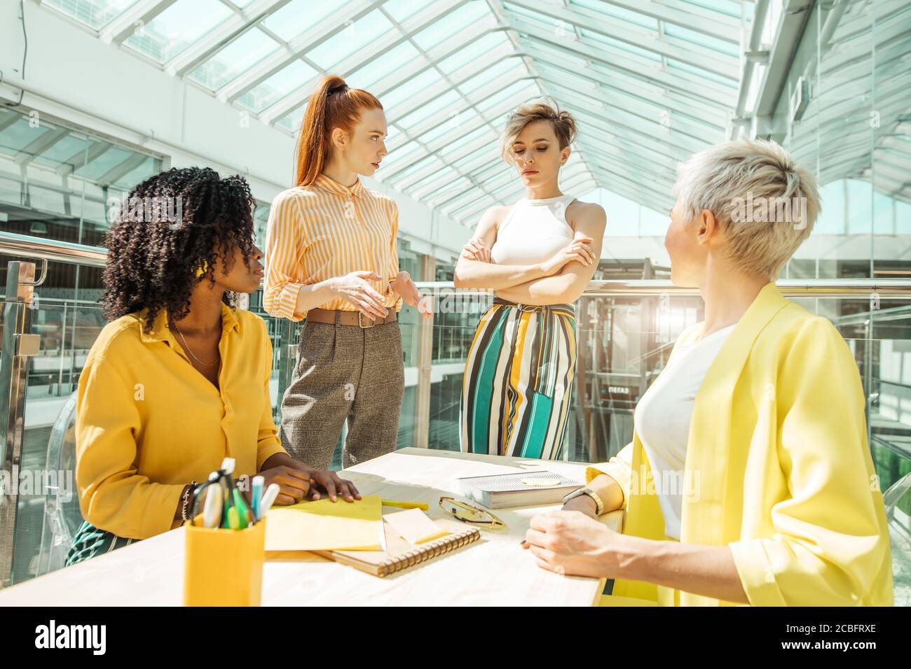 three women scolding their colleague. women tell of a new employee for her mistake, lateness. close up photo Stock Photo