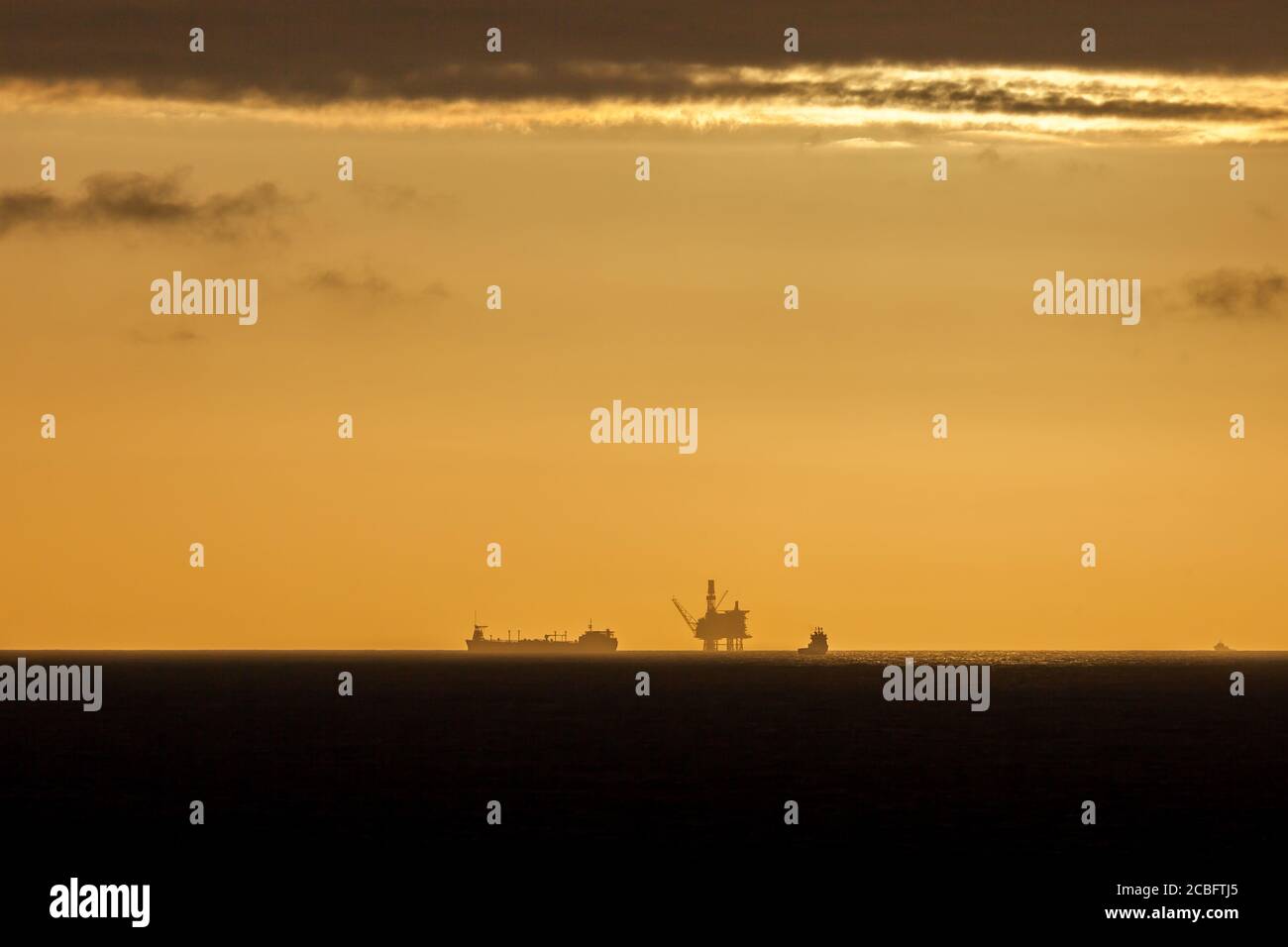 NORTH SEA, NORWAY - 2015 MAY. Beautiful sunset at offshore in the North Sea with oil platform in the horizon. Stock Photo