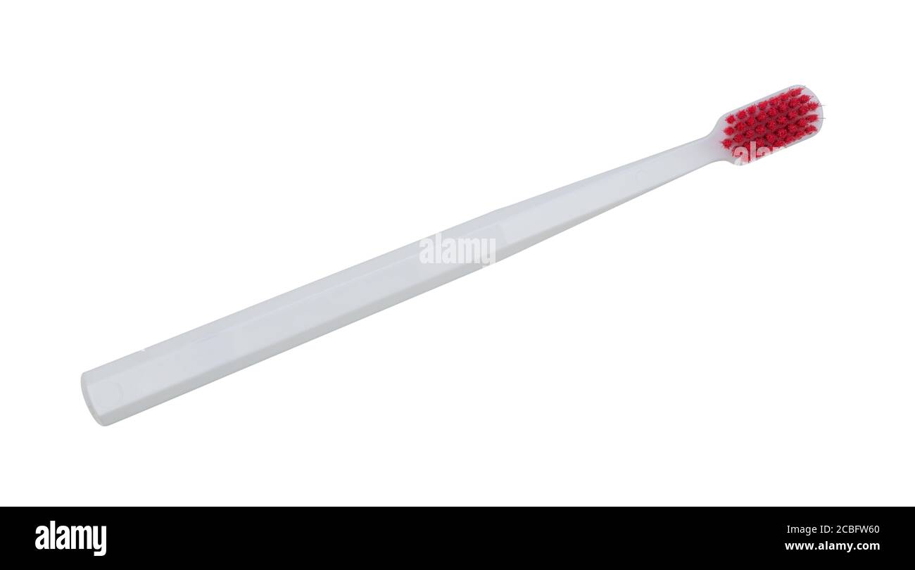 White toothbrush with red hairs isolated on a white background Stock Photo