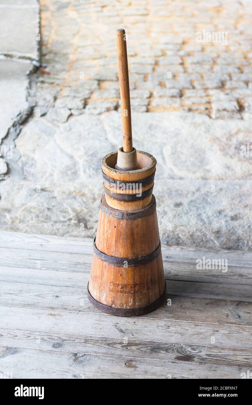 Butter churn - old traditional wooden plunger-type butter churn with staff Stock Photo