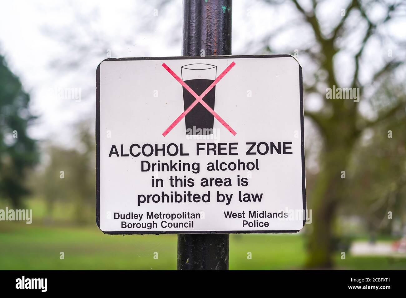 Alcohol Free Zone sign isolated outdoors on lamp post in UK park