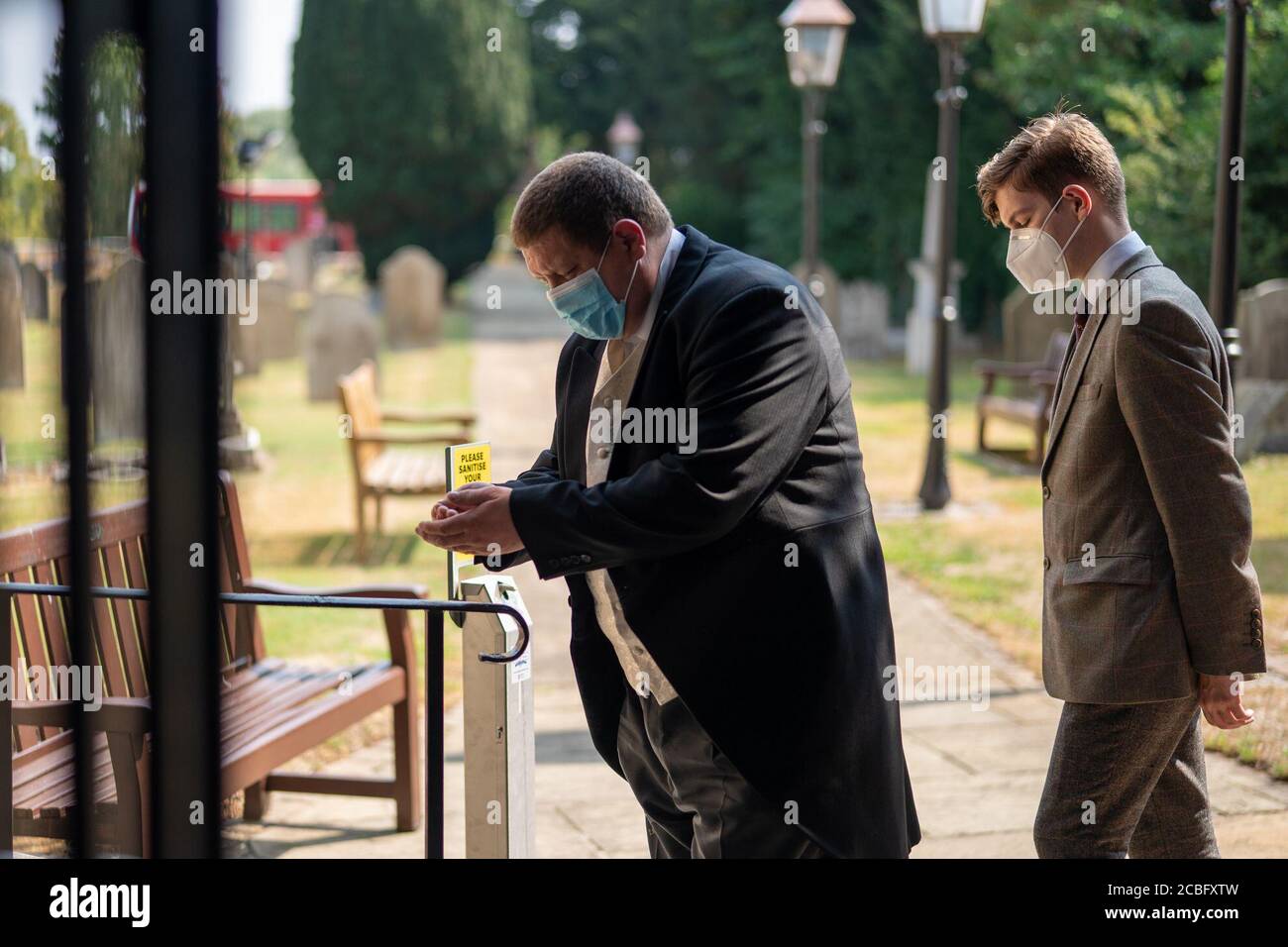 London, UK. Thursday, August 13, 2020. Guests sanitise their hands at the first wedding to be held at St GeorgeÕs church in Hanworth Park, London, since the lockdown. Photo: Roger Garfield/Alamy Live News Stock Photo