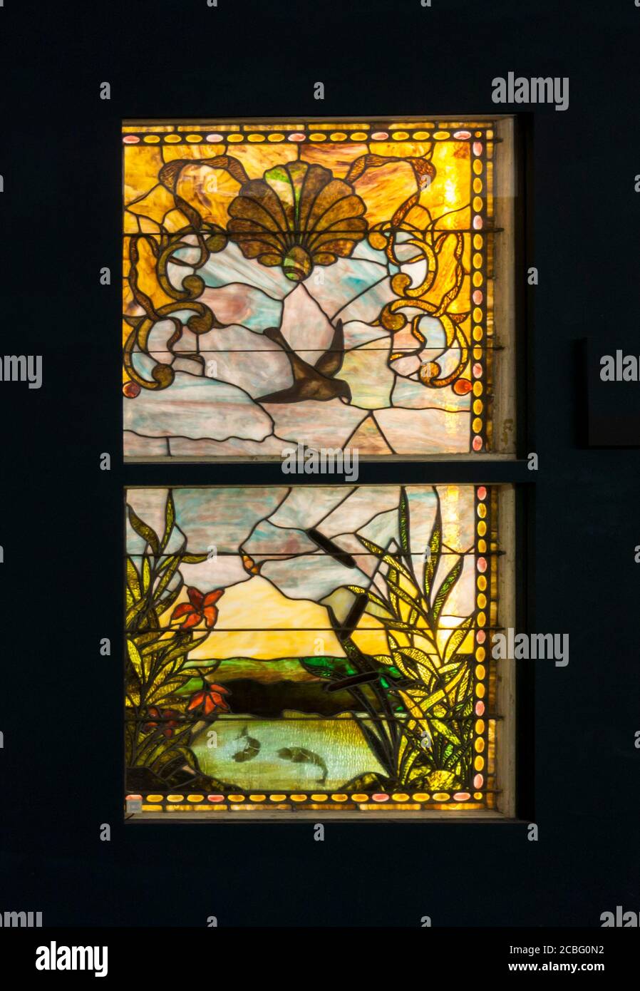 19th century American stained glass by unknown designer, showing a natural scene with fish in a lake. Displayed in Macy's Pedway, Chicago. Stock Photo