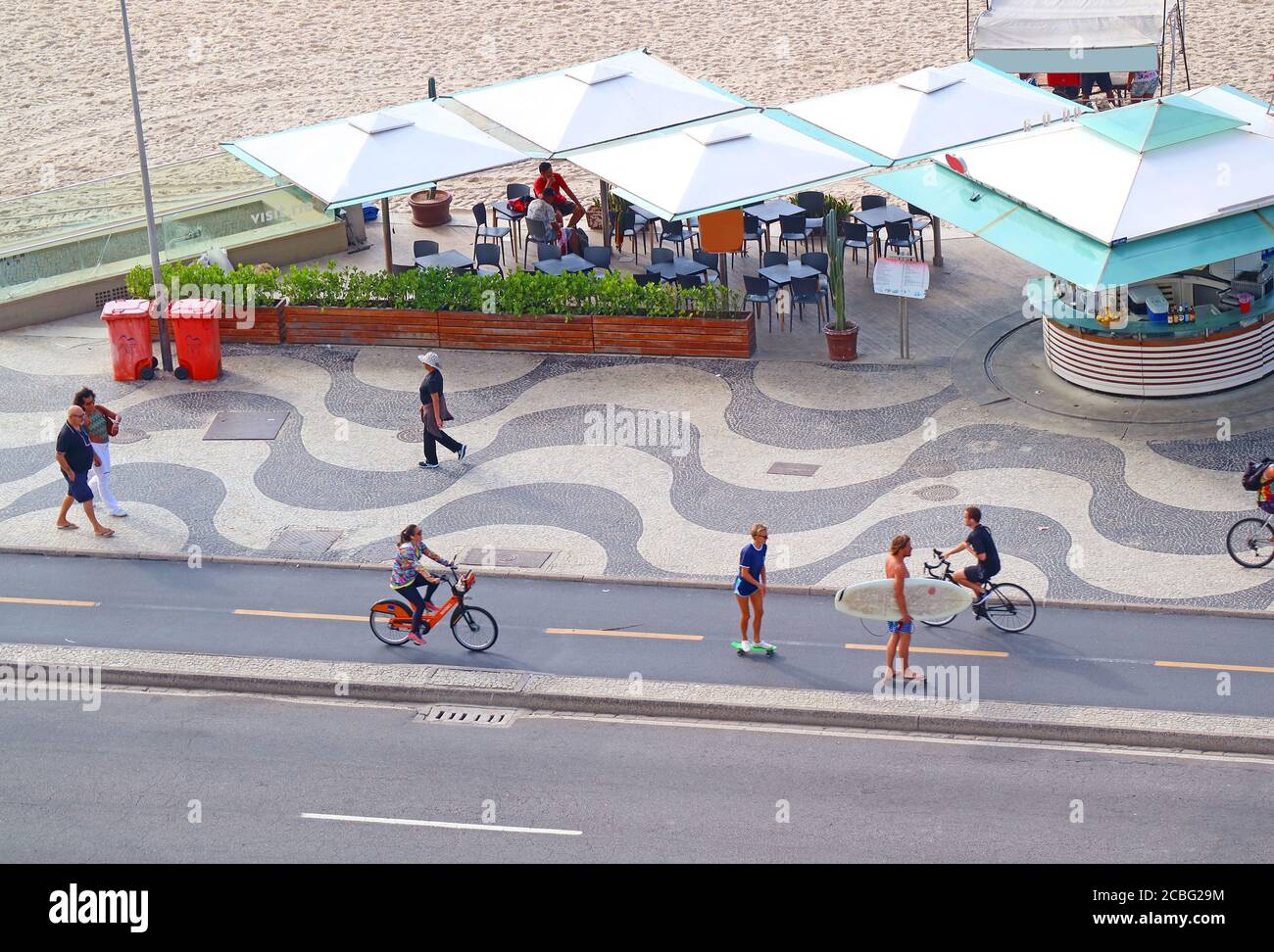 Group of people enjoy the activities on the street along Copacabana ...