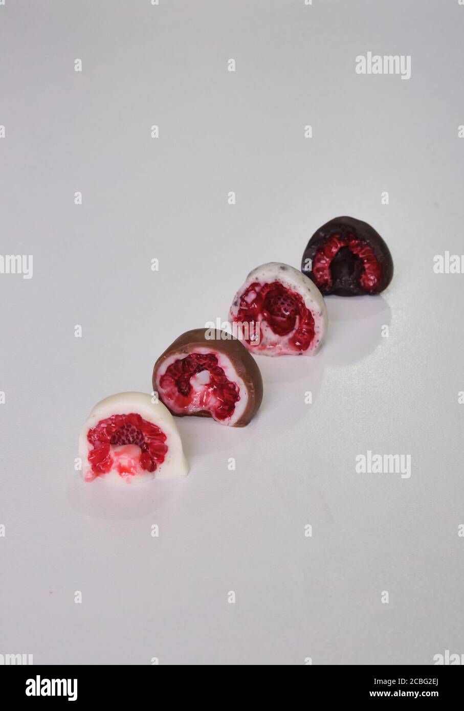raspberries dipped or covered in mold chocolate cut in half. Different
