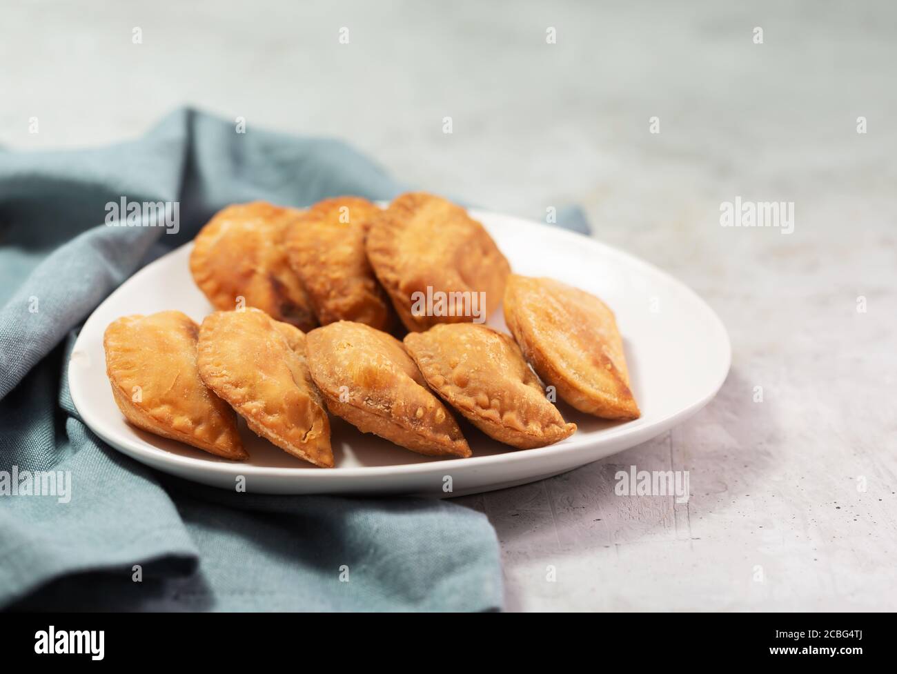 Typical Colombian empanadas usually served with spicy sauce on concrete surface Stock Photo