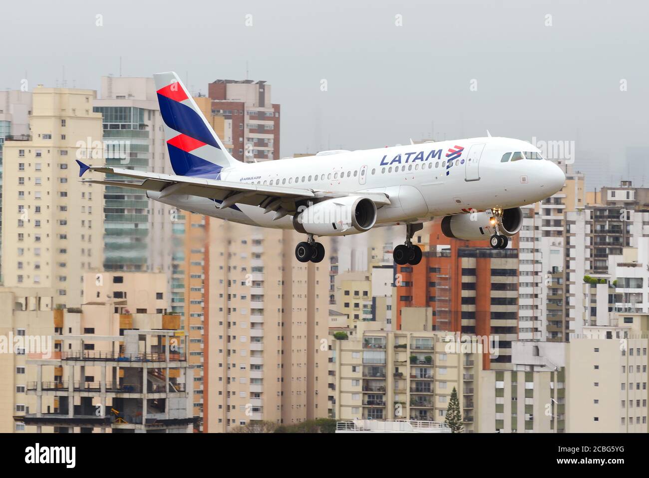 LATAM Airlines Airbus A319 on final approach to Sao Paulo Congonhas Airport in Brazil. Small aircraft landing in Brazilian central airport. Stock Photo