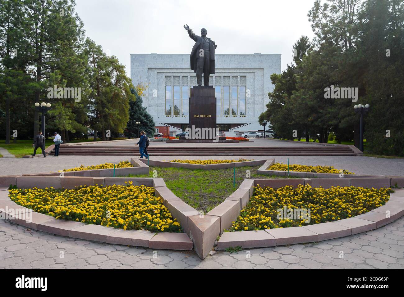 Vladimir Lenin statue moved to the back of the National Museum in  Bishkek, Kyrgyzstan. Vladimir Lenin monument with flowers around. Stock Photo