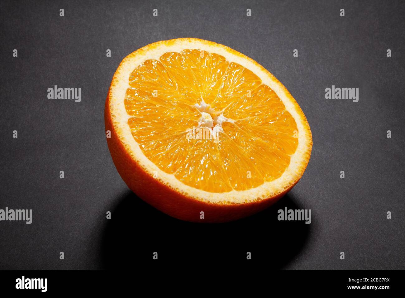 sliced orange fruit on black background Stock Photo