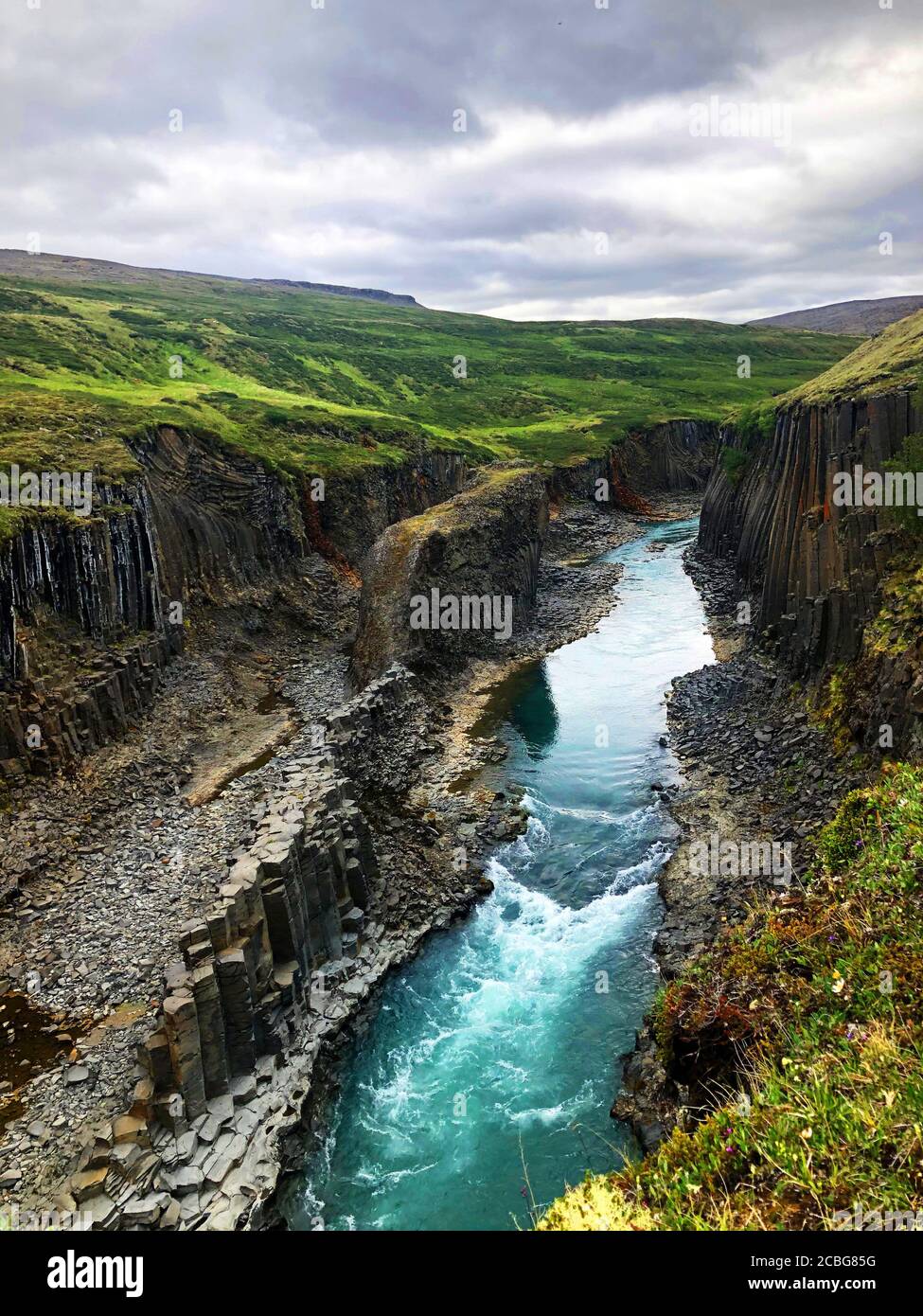 Turquoise Blue Waters and Basalt Columns at Studlagil Basalt Canyon in East Iceland Stock Photo