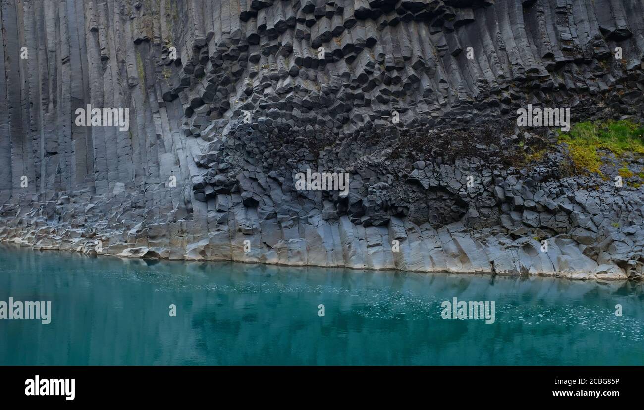Turquoise Blue waters and Basalt Columns at Studlagil Basalt Canyon in East Iceland Stock Photo