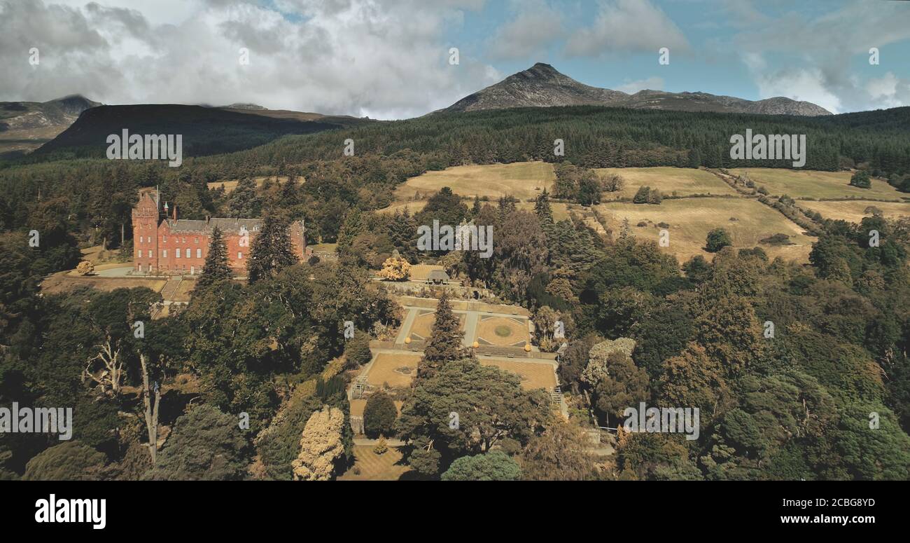 Scotland's ocean landscape shore aerial shot: trees and road with cars near Firth-of-Clyde Gulf. Magnificent coastline of nature with historical herit Stock Photo