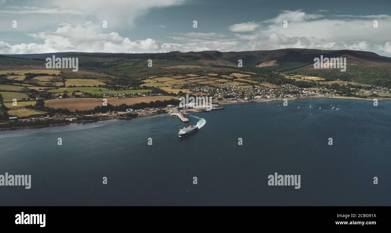 Scotland, Brodick Ferry Terminus aerial panoramic shot of ship crossing, Arran Island. Beautiful passenger ferry go from harbor at Firth-of-Clyde Gulf Stock Photo