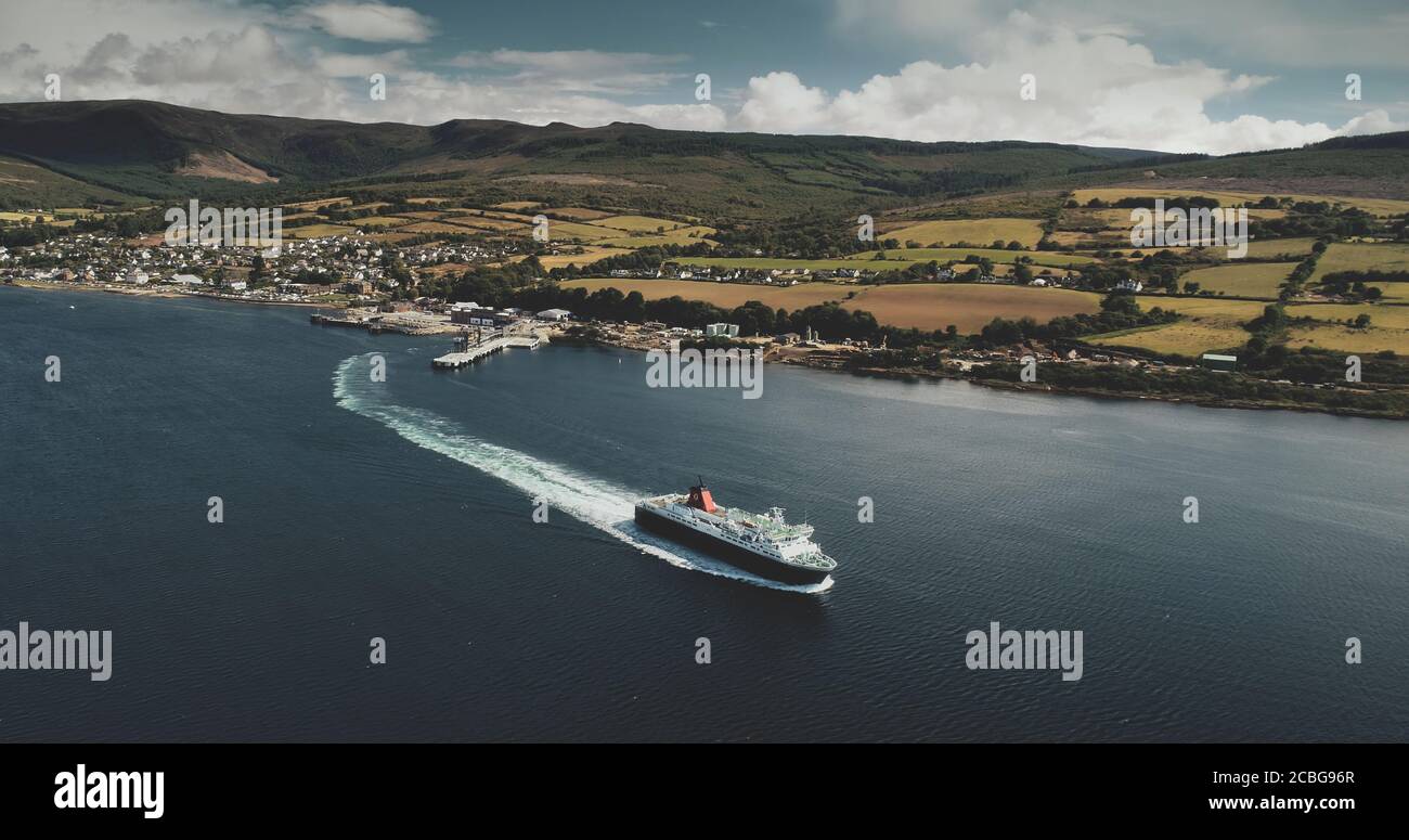 Scotland, Brodick Ferry Terminus aerial panoramic shot of ship crossing, Arran Island. Beautiful passenger ferry go from harbor at Firth-of-Clyde Gulf Stock Photo