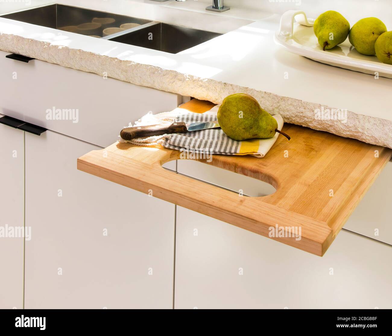 Contemporary White Kitchen with Concrete Countertop, Pull-Out Cutting Board Stock Photo