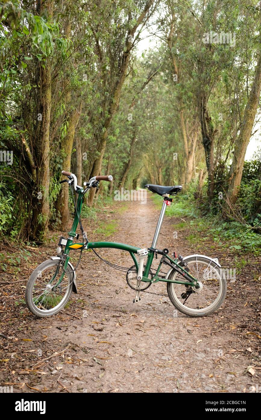 August 2020 - British folding Brompton bike on willow walk trail near Glastonbury. Stock Photo