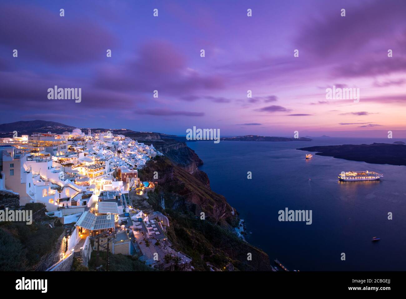 Romantic Santorini island during sunset, Greece, Europe. Romantic couple destination cruise ships amazing sunset sky city lights. Amazing landscape Stock Photo