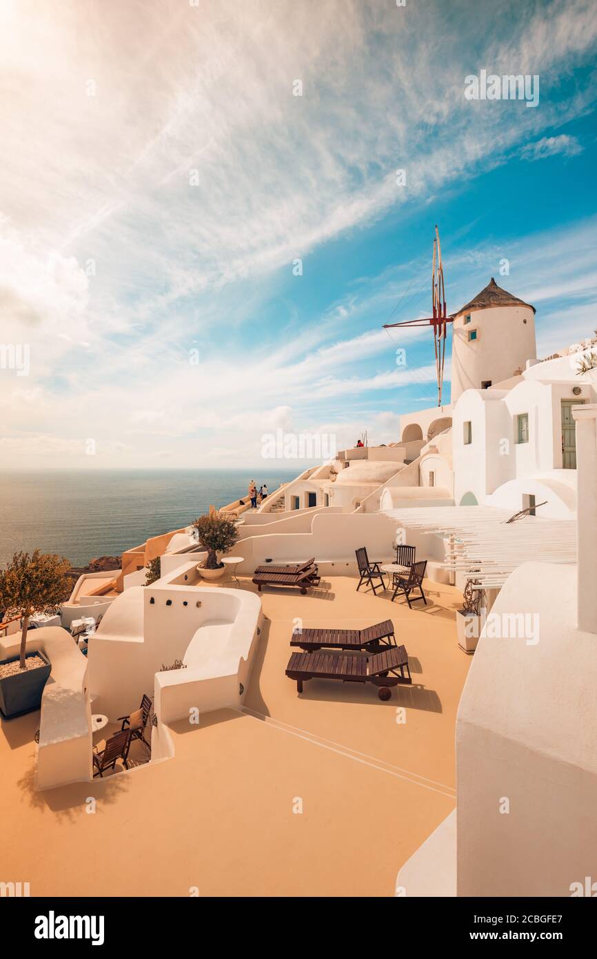 View of Oia the most beautiful village of Santorini Island in Greece. Idyllic summer travel landscape, holiday. Romantic chaise lounge couple vacation Stock Photo